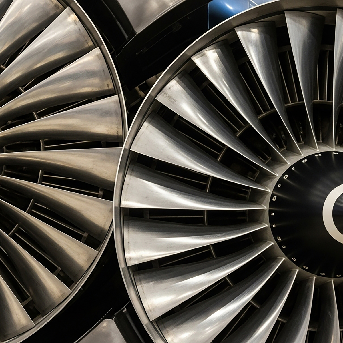 Close-up view of modern aircraft jet engines showcasing intricate turbine blade design, emphasizing aerospace engineering and technology.