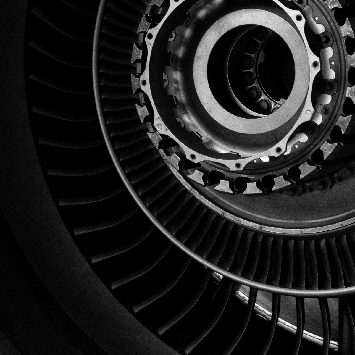 Close-up view of a jet engine turbine, showcasing intricate details of the rotor and fan blades, emphasizing its engineering design and functionality in aerospace technology.