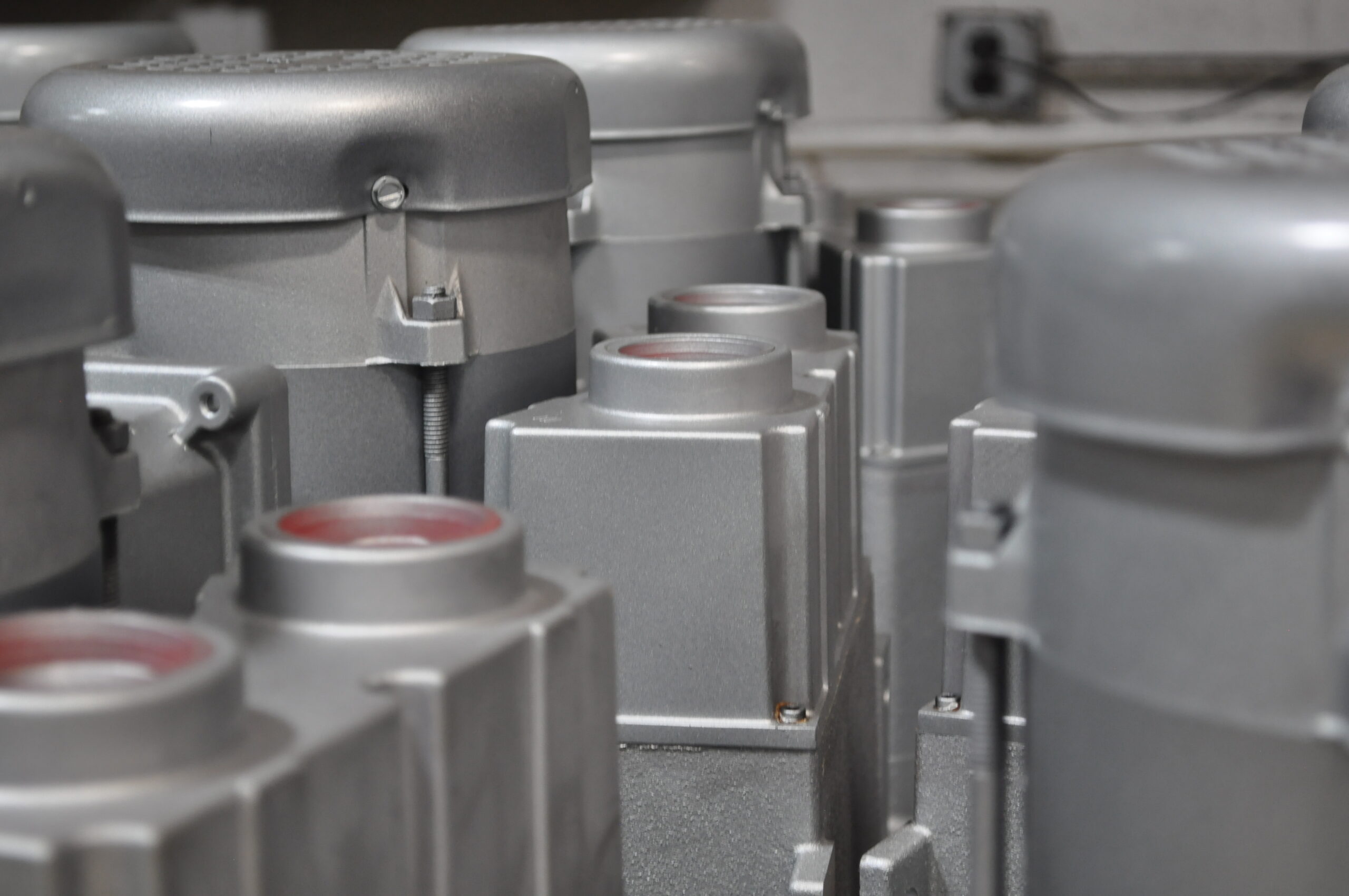 Close-up of metallic components in a green manufacturing facility, showcasing sustainable production practices with efficient machinery and eco-friendly materials.