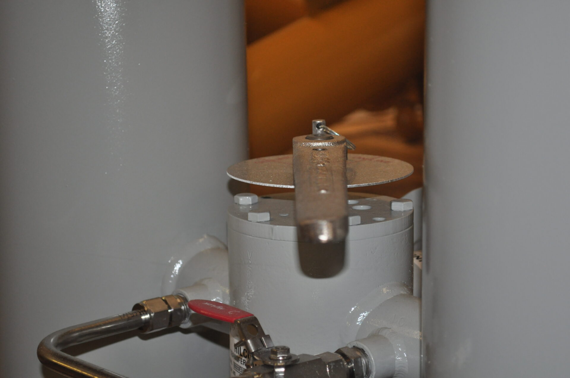 Close-up of a valve assembly featuring a round handwheel and attached piping, highlighting the mechanism used for regulating fluid flow in industrial applications.