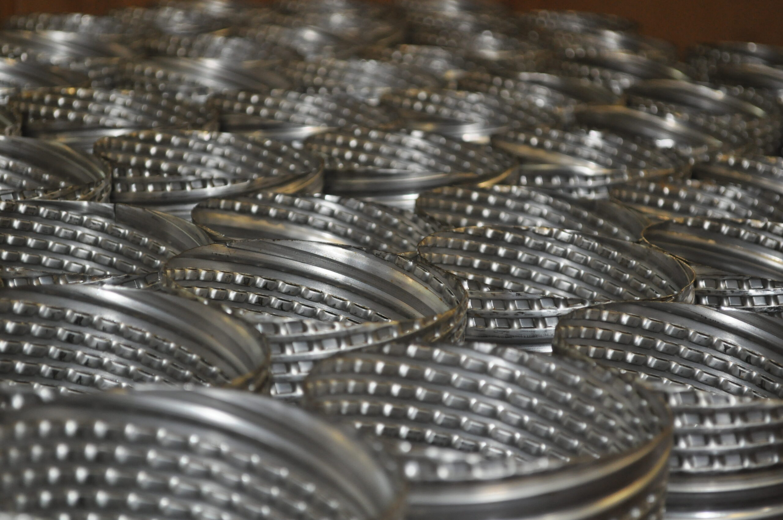 Close-up of stacked metal filter cartridges showcasing their textured design, ideal for various filtration applications.