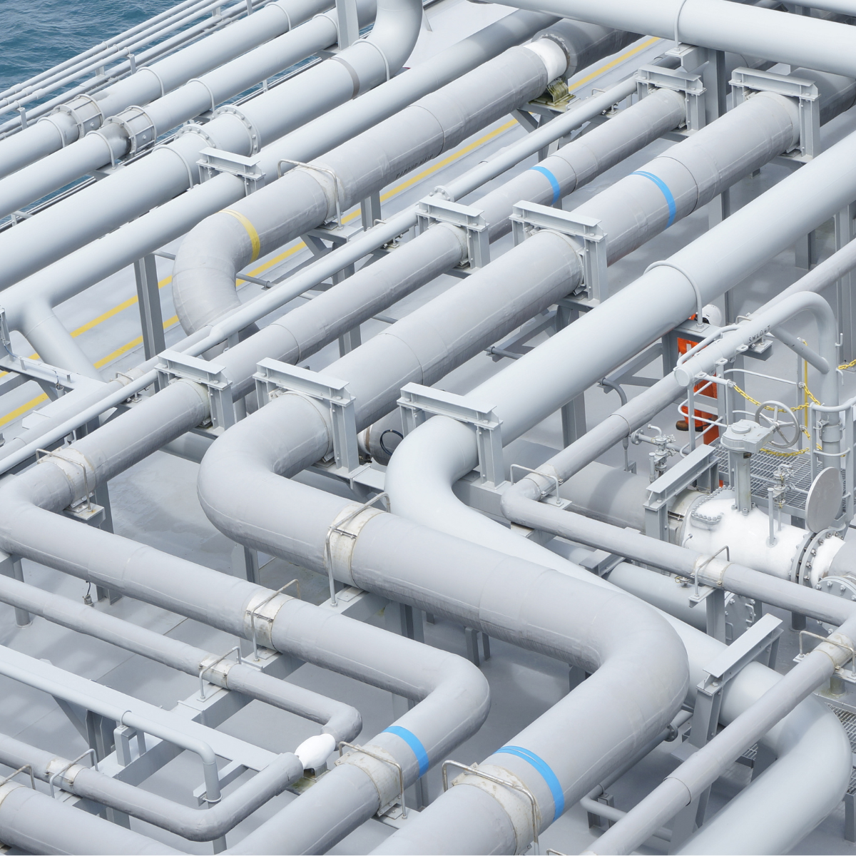 Aerial view of interconnected natural gas pipelines on a transmission platform, showcasing the complex network of pipes and valves used for efficient gas transport.