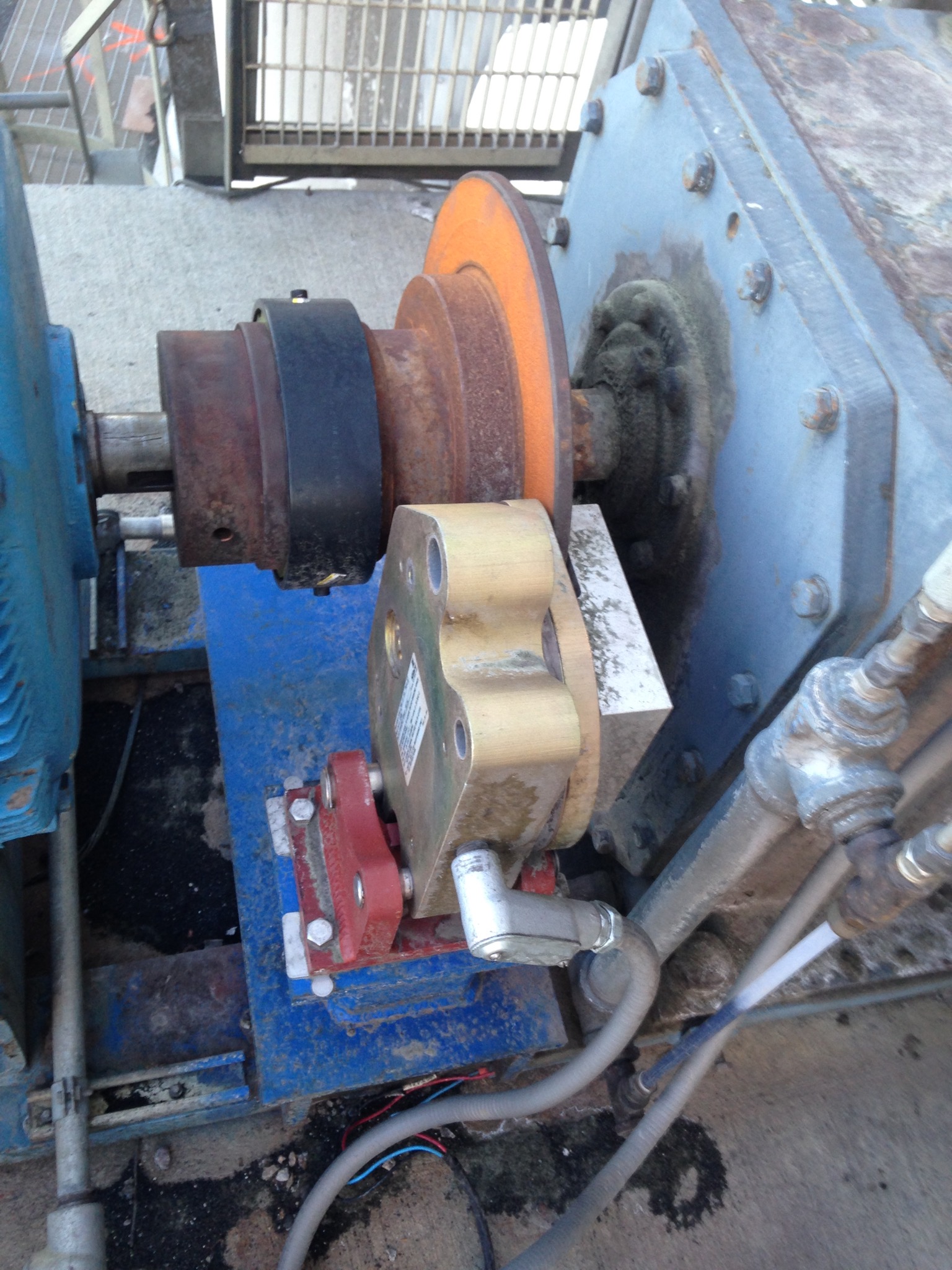 Industrial pump and motor assembly showing a rusted rotor and connection points, illustrating repair needs for mechanical equipment in maintenance services.