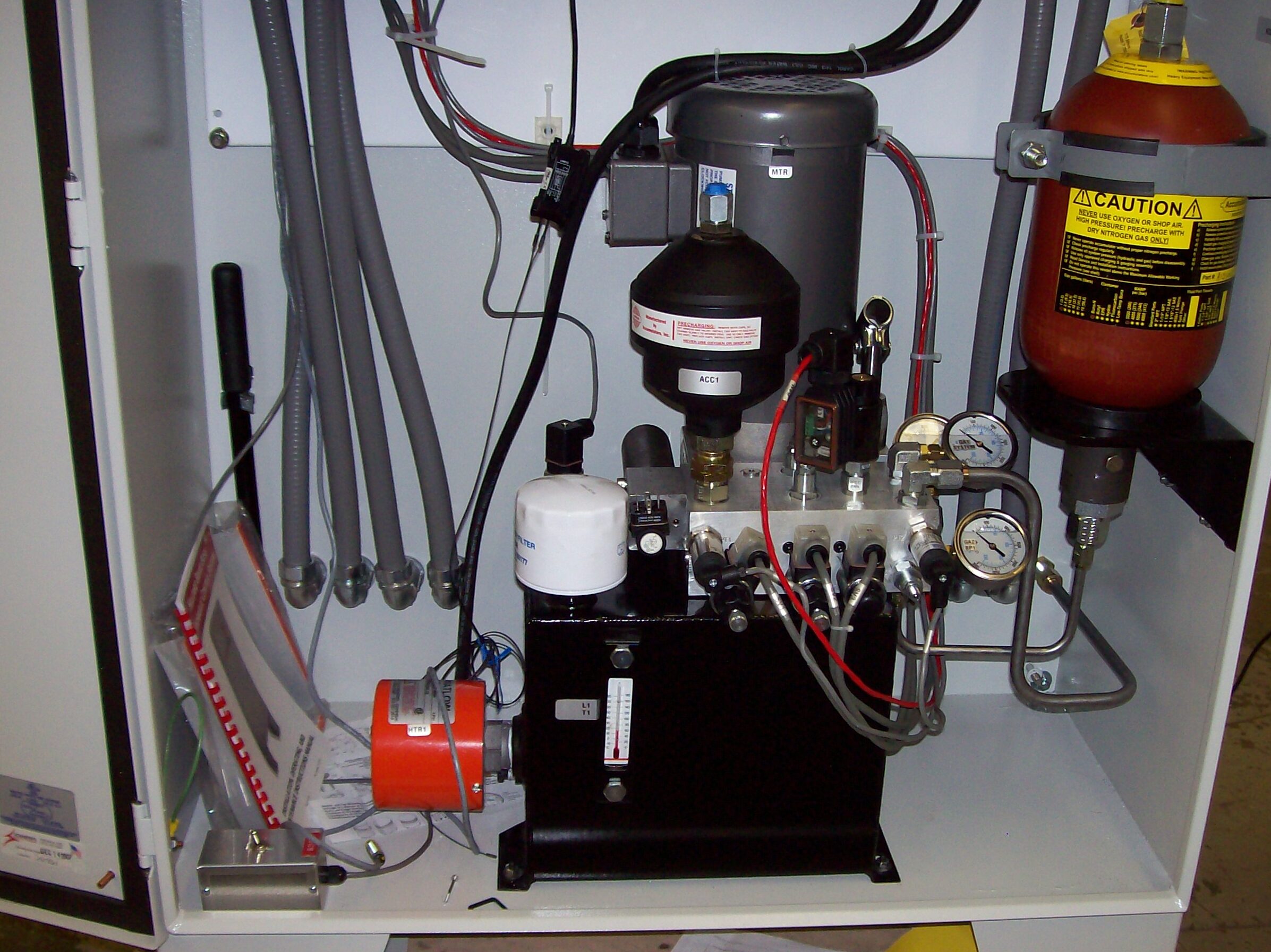 Internal view of a repair service equipment cabinet, showcasing various components including a compressor, gauges, and hoses, essential for maintenance and troubleshooting industrial machinery.