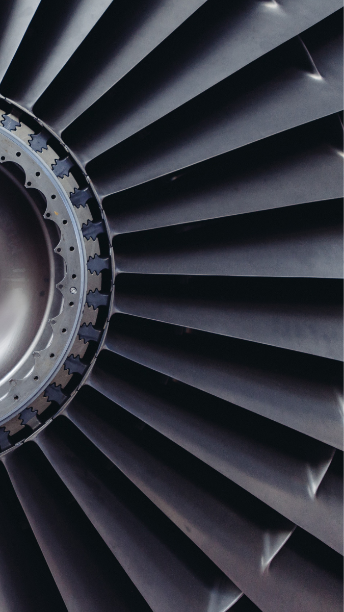 Close-up of a gas turbine engine, showcasing the intricate blades and central hub, emphasizing its role in power generation and efficiency in energy production.