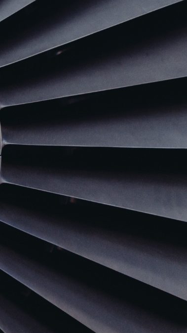 Close-up of a gas turbine engine, showcasing the intricate blades and central hub, emphasizing its role in power generation and efficiency in energy production.