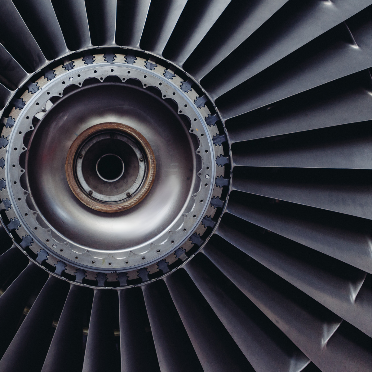 Close-up of a gas turbine engine, showcasing the intricate blades and central hub, emphasizing its role in power generation and efficiency in energy production.