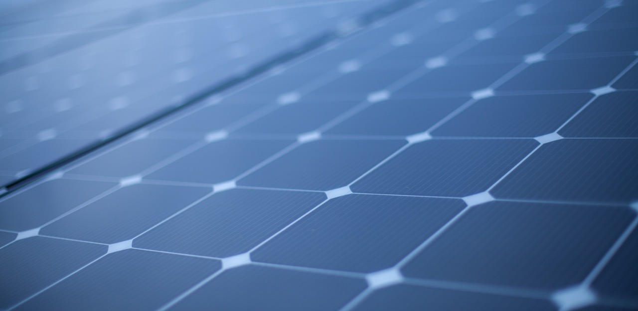 Close-up view of solar panels showcasing their blue photovoltaic cells, designed for harnessing solar energy for renewable power generation.