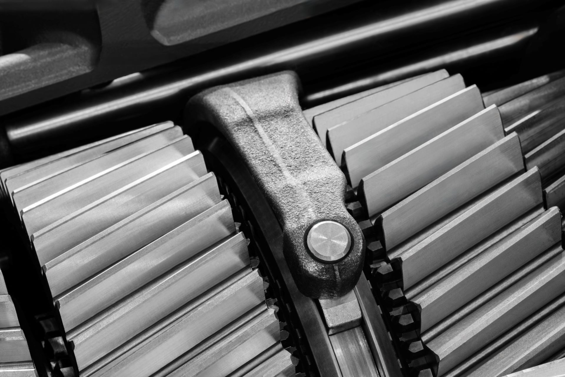 Close-up view of interlocking metal gears with a focus on the textured surface and polished edges, highlighting mechanical engineering and precision manufacturing.